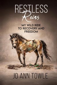 Book cover showing a collage-style horse made of papers and debris on a dusty ground; title 'Restless Reins' and subtitle 'My Wild Ride to Recovery and Freedom' by Jo Ann Towle.