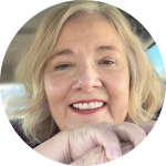 Kathleen Dian | GracePoint Publishing Close-up of a smiling older woman with blonde hair, resting her chin on her clasped hands inside a circular frame